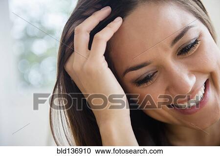 Woman running fingers through her hair View Large Photo Image Stock Image - Woman running fingers through her hair. Fotosearch