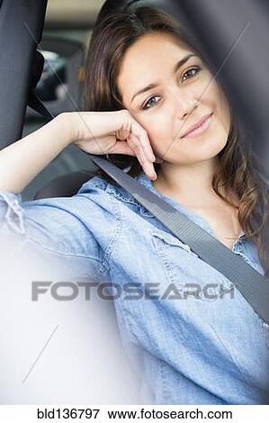 Stock Photo - Woman smiling in car. Fotosearch