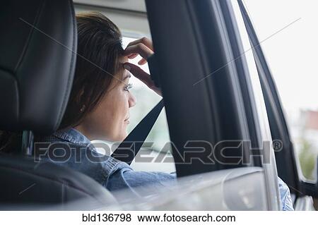 Stock Photo - Woman smiling in car. Fotosearch
