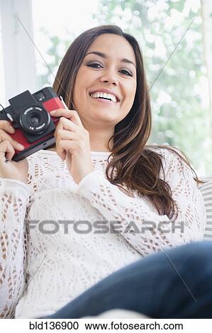 Stock Image - Woman taking pictures with camera. Fotosearch