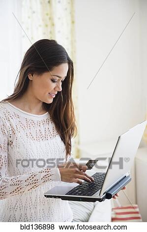 Woman using laptop in bedroom View Large Photo Image Stock Photo - Woman using laptop in bedroom. Fotosearch