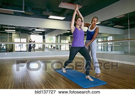 Woman working with yoga teacher in studio View Large Photo Image Stock Photo - Woman working with yoga teacher in studio. Fotosearch