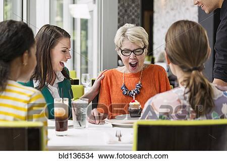 Picture - Women celebrating birthday in restaurant. Fotosearch