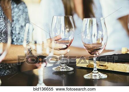 Stock Photography - Women drinking wine together in bar. Fotosearch