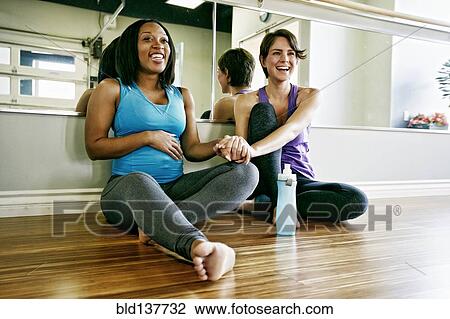 Women holding hands in yoga studio View Large Photo Image Stock Image - Women holding hands in yoga studio. Fotosearch
