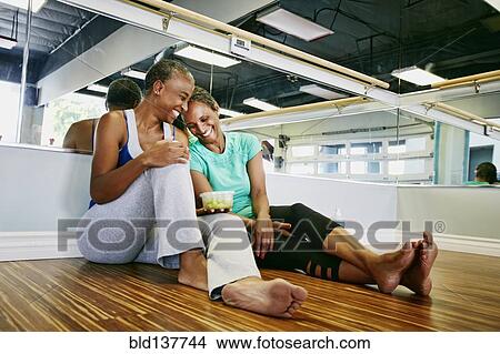 Picture - Women laughing in yoga studio. Fotosearch