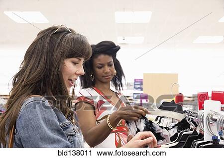 Stock Image - Women shopping together in store. Fotosearch