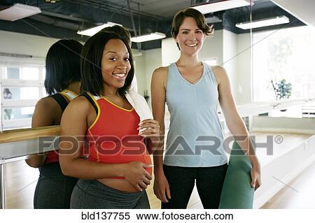 Stock Photography - Women smiling in yoga studio. Fotosearch
