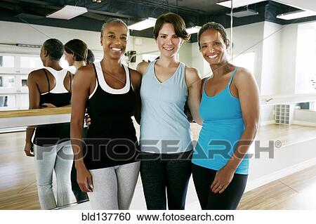 Women smiling together in yoga studio View Large Photo Image Stock Image - Women smiling together in yoga studio. Fotosearch