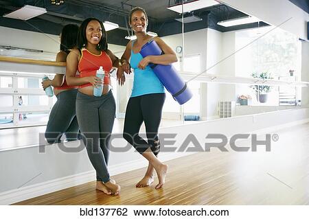 Women smiling together in yoga studio View Large Photo Image Stock Image - Women smiling together in yoga studio. Fotosearch