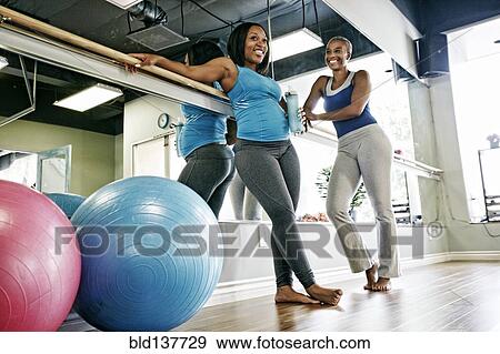 Stock Photo - Women talking in yoga studio. Fotosearch