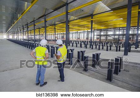 Stock Photo - Workers examining warehouse. Fotosearch