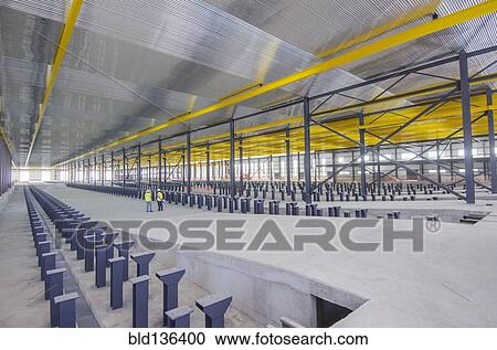 Stock Image - Workers standing in warehouse. Fotosearch