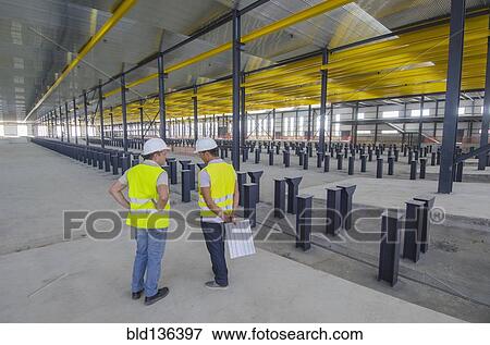 Workers talking in warehouse View Large Photo Image Stock Photo - Workers talking in warehouse. Fotosearch