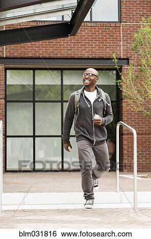 Stock Photograph - Black man walking in city. Fotosearch