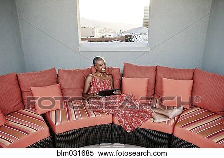 Black woman using digital tablet on urban rooftop View Large Photo Image Stock Photography - Black woman using digital tablet on urban rooftop. Fotosearch