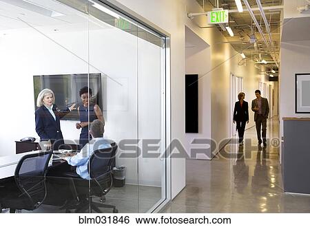 Stock Photograph - Business people talking in office. Fotosearch