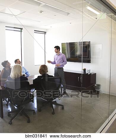 Stock Image - Businessman talking in meeting. Fotosearch
