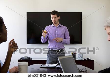 Businessman talking in meeting View Large Photo Image Stock Image - Businessman talking in meeting. Fotosearch