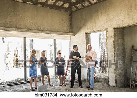 Picture - Caucasian architects talking at construction site. Fotosearch
