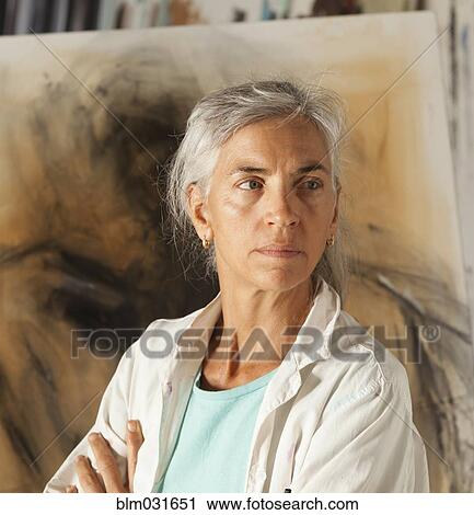 Stock Image - Caucasian artist standing in studio. Fotosearch