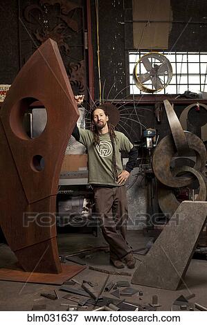 Stock Photo - Caucasian artist standing in studio. Fotosearch