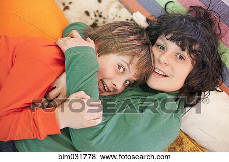 Stock Photo - Caucasian boys playing indoors. Fotosearch