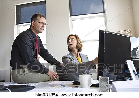 Caucasian business people talking in office View Large Photo Image Picture - Caucasian business people talking in office. Fotosearch
