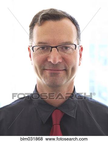 Stock Photo - Caucasian businessman smiling in office. Fotosearch