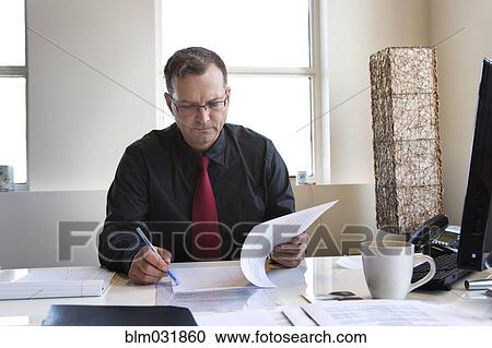 Caucasian businessman working at desk View Large Photo Image Stock Image - Caucasian businessman working at desk. Fotosearch