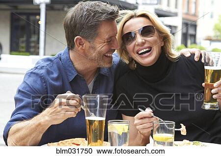 Caucasian couple drinking and eating at sidewalk cafe View Large Photo Image Stock Image - Caucasian couple drinking and eating at sidewalk cafe. Fotosearch