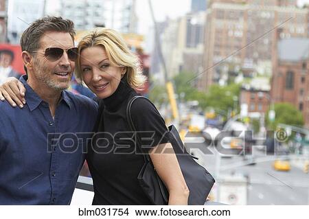 Picture - Caucasian couple hugging in city, New York City, New York, United States. Fotosearch