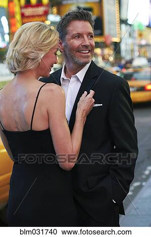 Stock Image - Caucasian couple hugging in Times Square, New York City, New York, United States. Fotosearch
