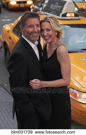 Stock Photo - Caucasian couple hugging near taxi, New York City, New York, United States. Fotosearch