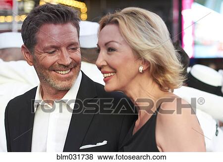 Stock Photo - Caucasian couple talking in Times Square, New York City, New York, United States. Fotosearch