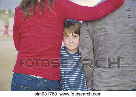 Stock Photo - Caucasian family standing outdoors. Fotosearch