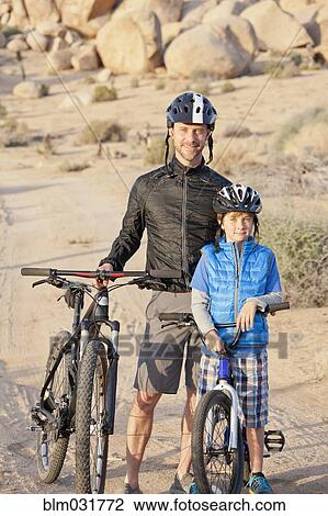 Caucasian father and son riding bicycles in desert landscape View Large Photo Image Stock Image - Caucasian father and son riding bicycles in desert landscape. Fotosearch