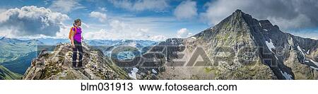 Stock Image - Caucasian girl hiking on rocky mountain. Fotosearch