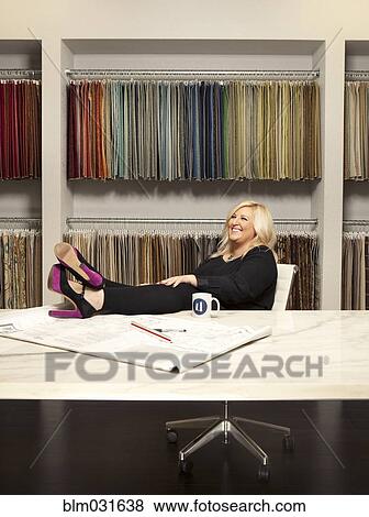 Caucasian interior designer sitting in studio View Large Photo Image Stock Photo - Caucasian interior designer sitting in studio. Fotosearch
