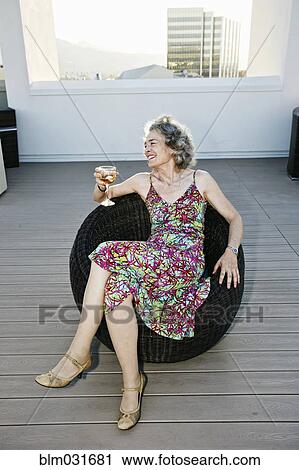 Caucasian woman drinking wine on urban rooftop View Large Photo Image Stock Image - Caucasian woman drinking wine on urban rooftop. Fotosearch
