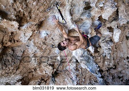Climber hanging from rocky cave ceiling View Large Photo Image Stock Photo - Climber hanging from rocky cave ceiling. Fotosearch