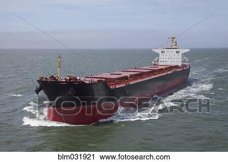 Stock Image - Container ship sailing on calm sea. Fotosearch