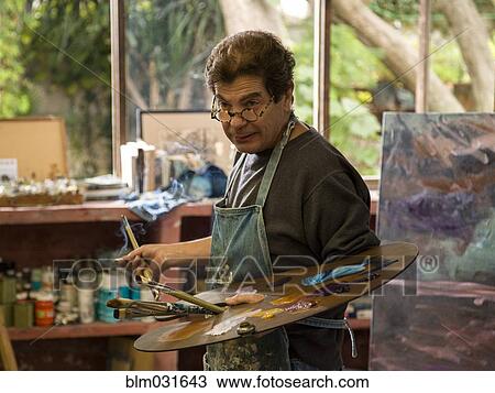 Hispanic artist holding palette in studio View Large Photo Image Stock Image - Hispanic artist holding palette in studio. Fotosearch
