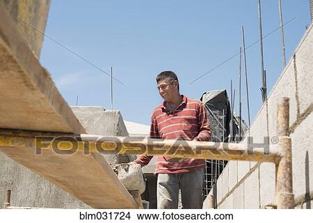 Hispanic construction worker at construction site View Large Photo Image Picture - Hispanic construction worker at construction site. Fotosearch