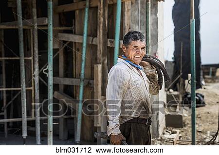 Stock Image - Hispanic construction worker at construction site. Fotosearch