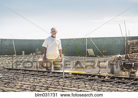 Stock Image - Hispanic construction worker at construction site. Fotosearch