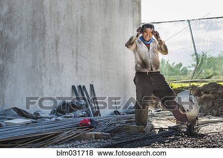 Hispanic construction worker at construction site View Large Photo Image Stock Photo - Hispanic construction worker at construction site. Fotosearch