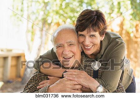 Stock Photograph - Hispanic father and daughter hugging. Fotosearch