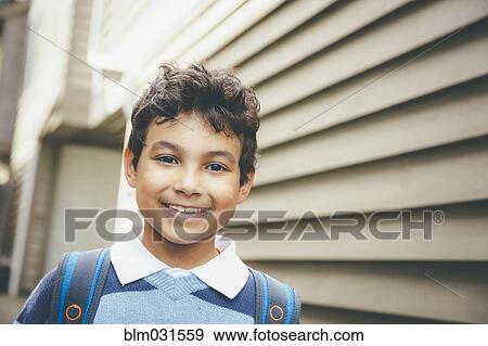 Mixed race boy smiling near house View Large Photo Image Stock Photo - Mixed race boy smiling near house. Fotosearch