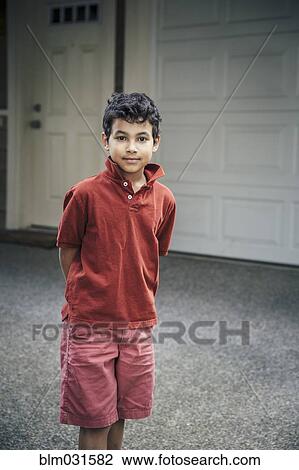 Mixed race boy standing on driveway View Large Photo Image Stock Image - Mixed race boy standing on driveway. Fotosearch